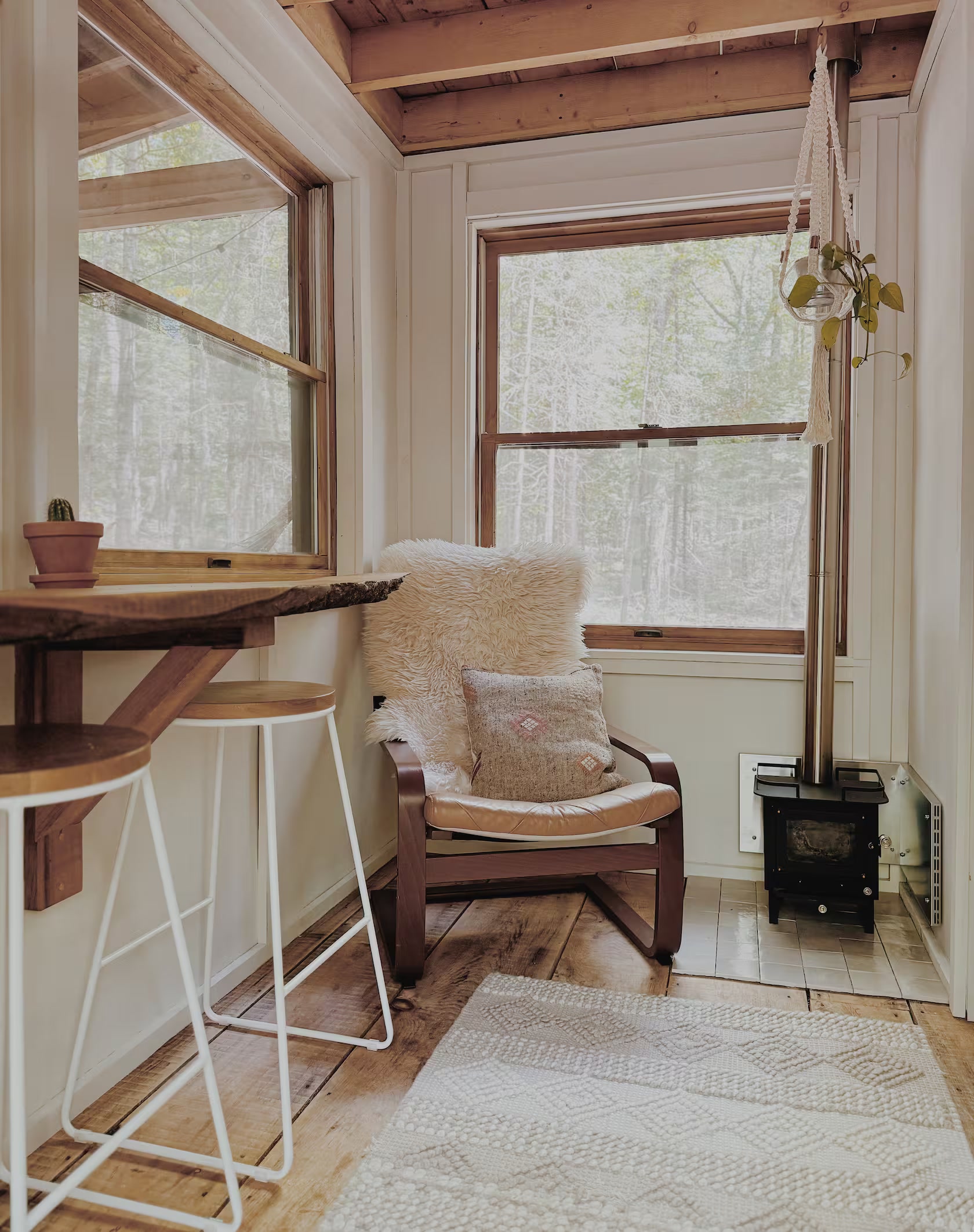 Pale wood interior with custom live-edge counter and wood stove